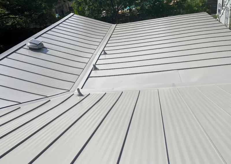 Solar attic fan installed on a metal roof for Roof Ventilation in Bozeman
